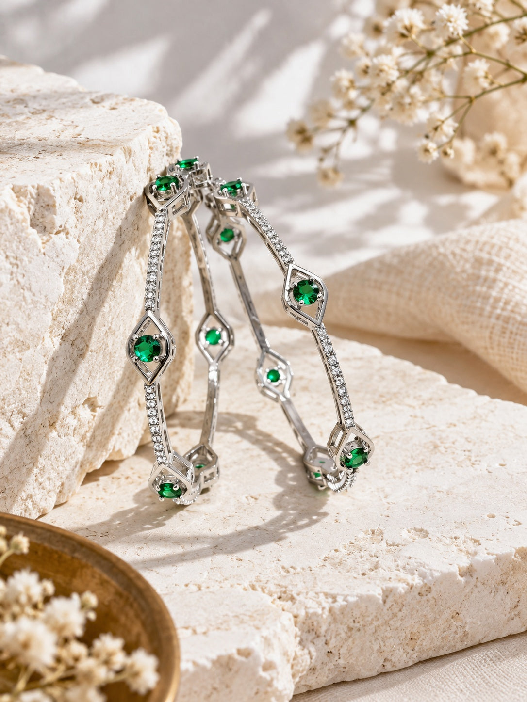 Niska silver plated green stone bangles worn on crossed hands in cream linen