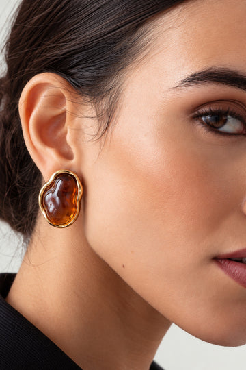 Close-up model image wearing amber resin stone gold earrings