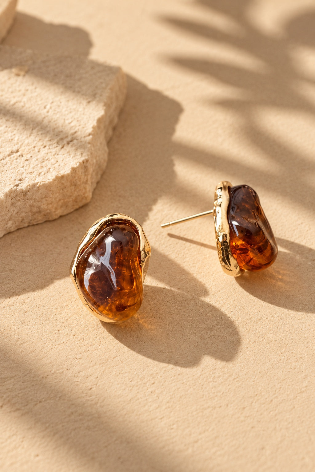 Amber resin stone gold earrings showing side profile