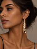 Niska gold-tone textured Resin drop earring worn by model