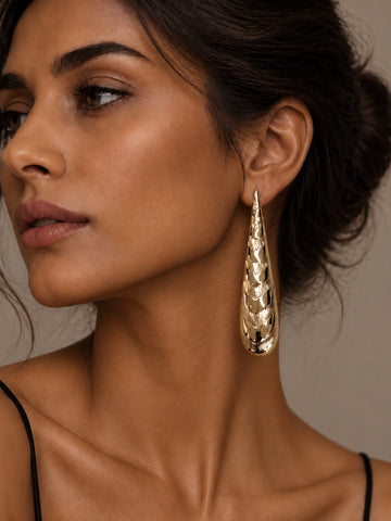 Niska gold-tone textured Resin drop earring worn by model