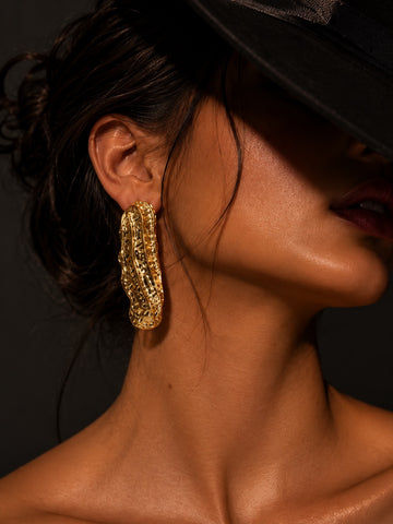 Niska peanut shell gold plated statement earring on model
