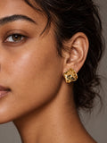 Niska gold tone sculptural hammered stud earrings on model with natural skin