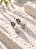 Niska white marble-effect Resin stud earrings – angled close-up