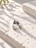 Niska white marble-effect Resin stud earrings – front product view