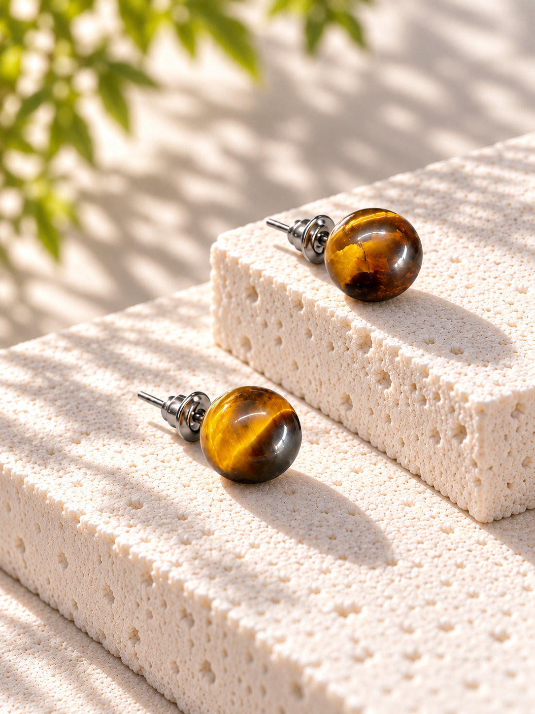 Amber brown round stud earrings on sunlit travertine — view 6