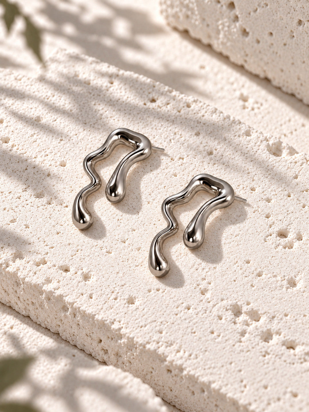 Niska silver-tone fluid wave statement earrings on white travertine – view 3 – ER26N10241