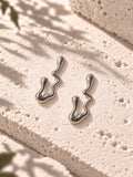 Niska silver-tone fluid wave statement earrings on white travertine – view 6 – ER26N10241