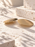 Niska gold-tone Resin disc earrings on white travertine 2