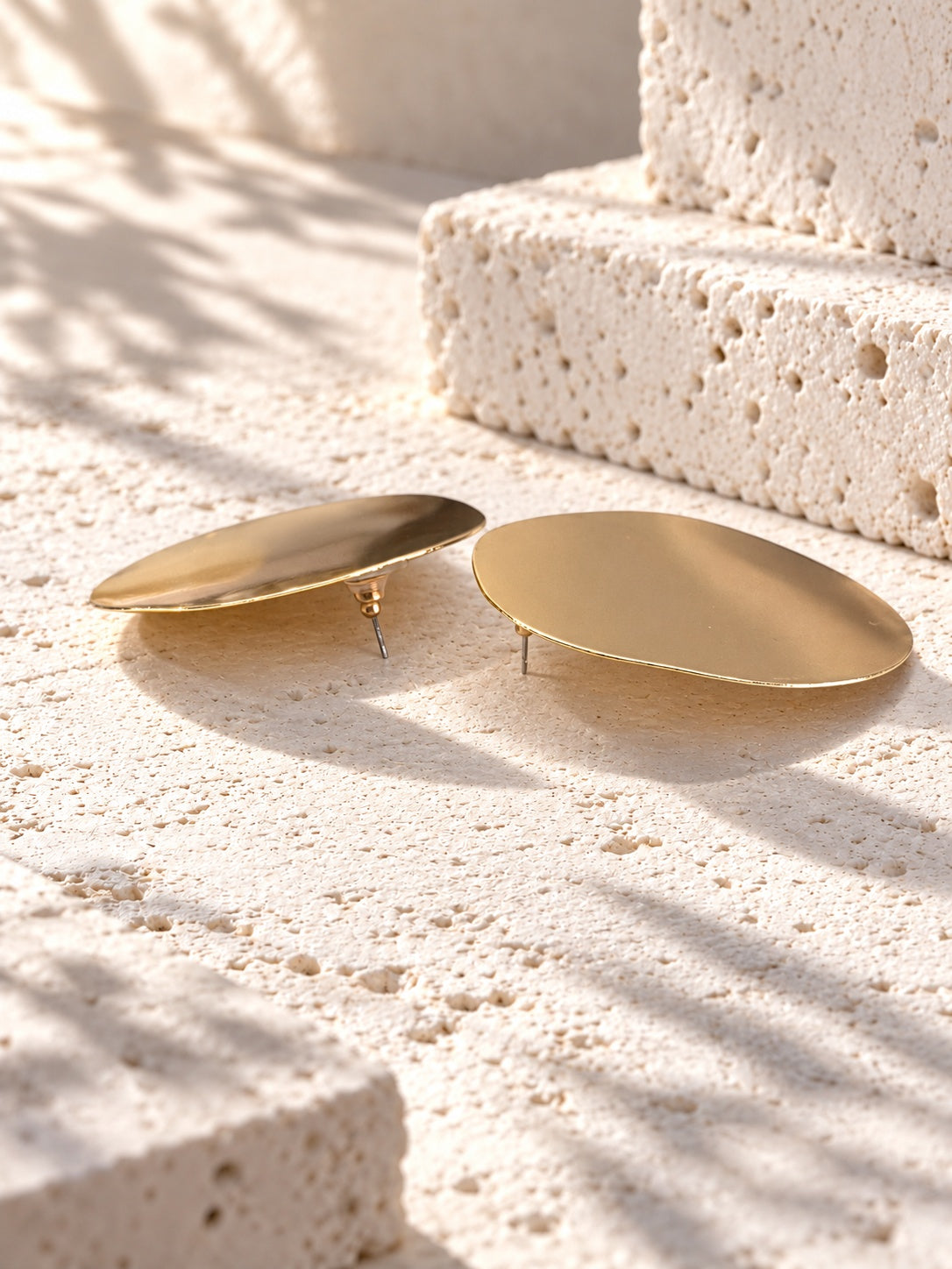 Niska gold-tone Resin disc earrings on white travertine 2