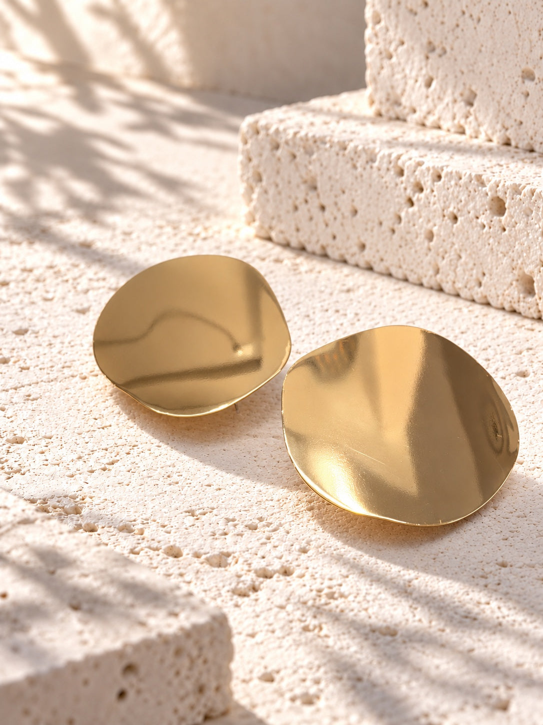 Niska gold-tone Resin disc earrings on white travertine 3