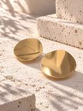 Niska gold-tone Resin disc earrings on white travertine 4