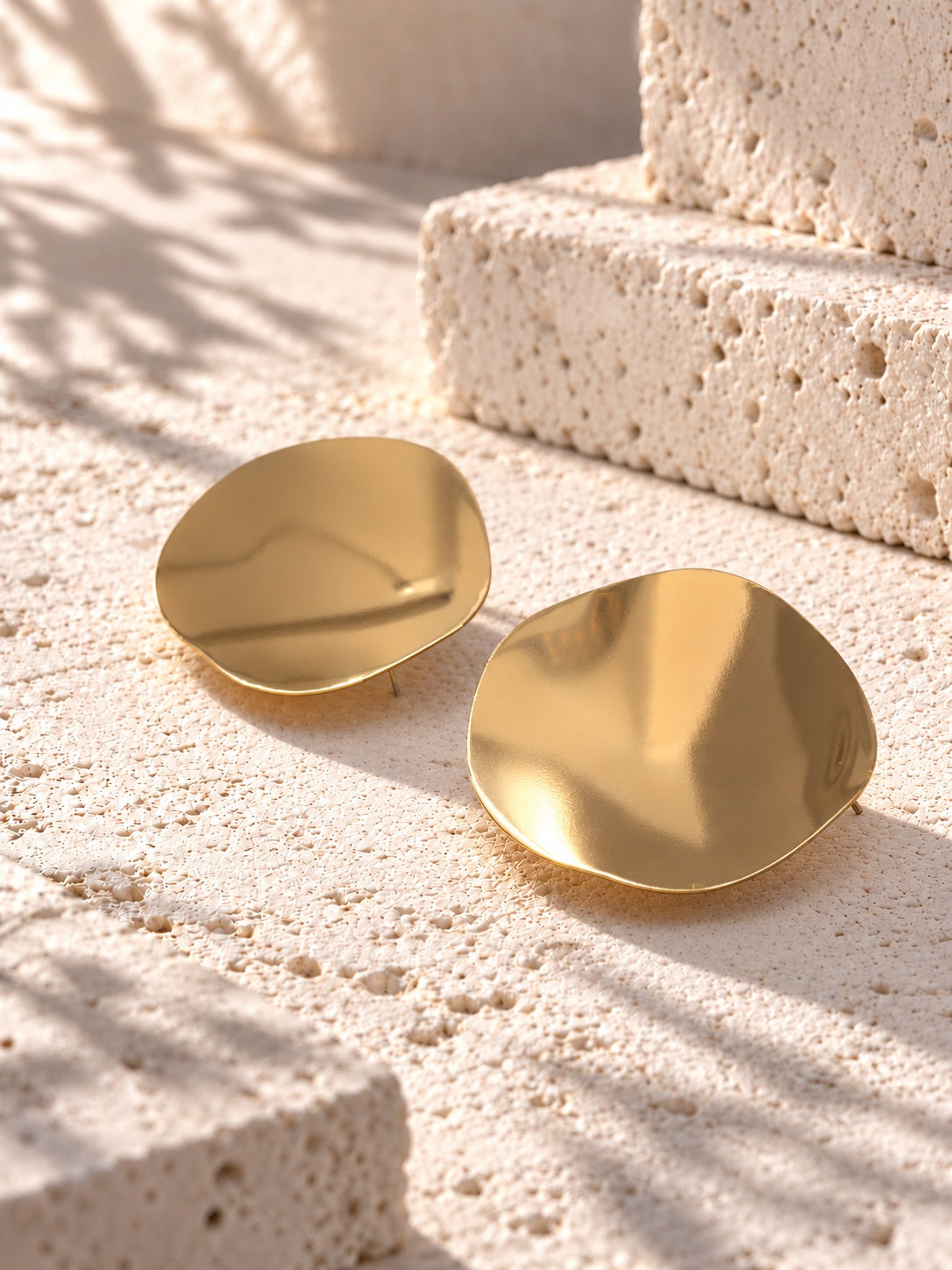 Niska gold-tone Resin disc earrings on white travertine 4