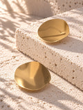 Niska gold-tone Resin disc earrings on white travertine 5