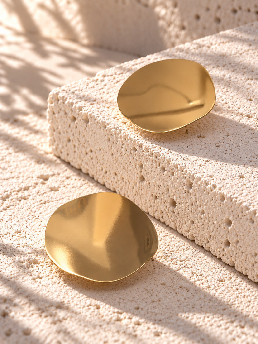 Niska gold-tone Resin disc earrings on white travertine 5