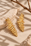 Close-up flat lay of textured gold earrings