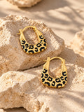 Gold leopard-print hoop earrings editorial product photo