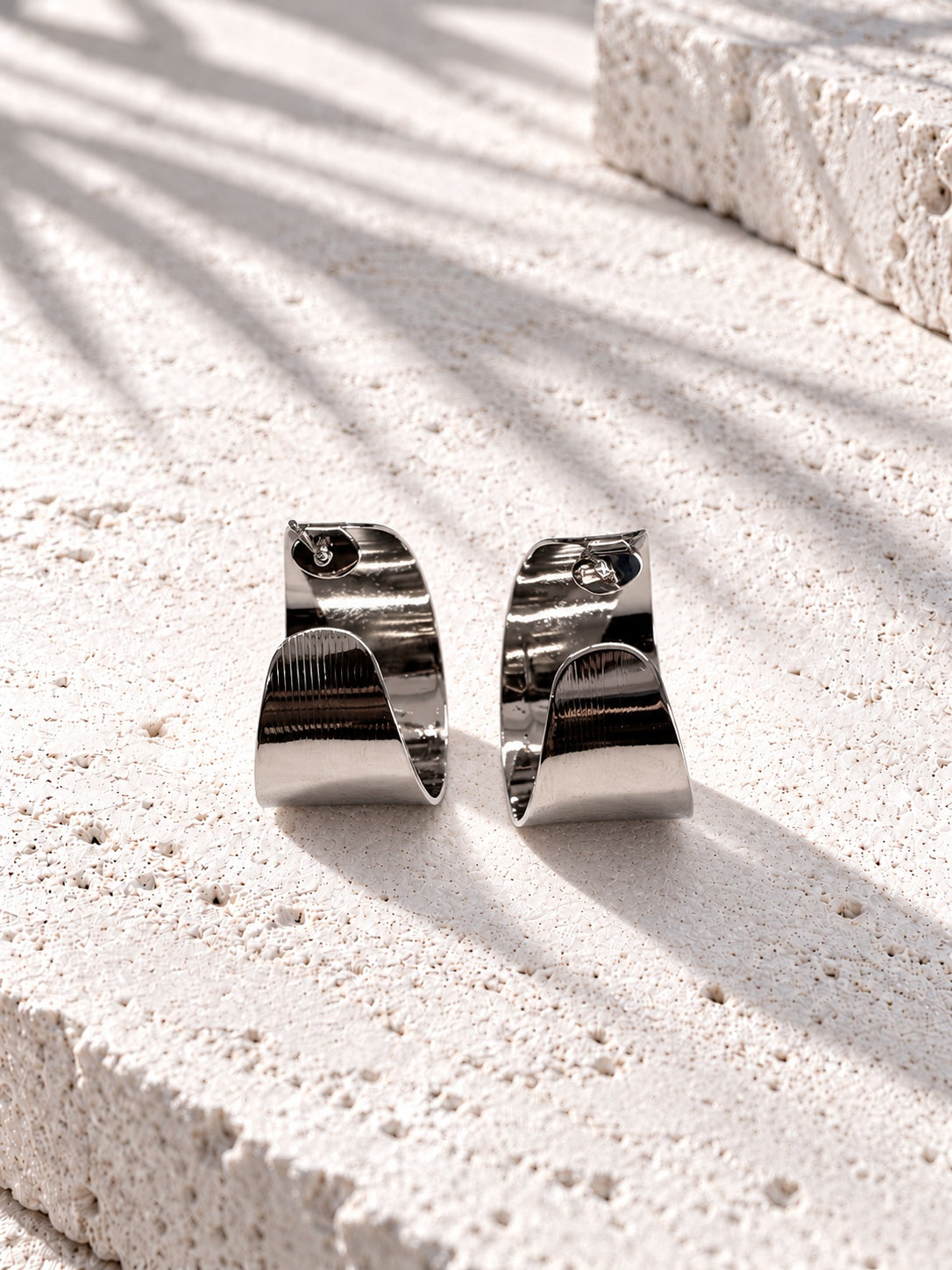 Niska silver-tone sculptural alloy hoop earrings front view