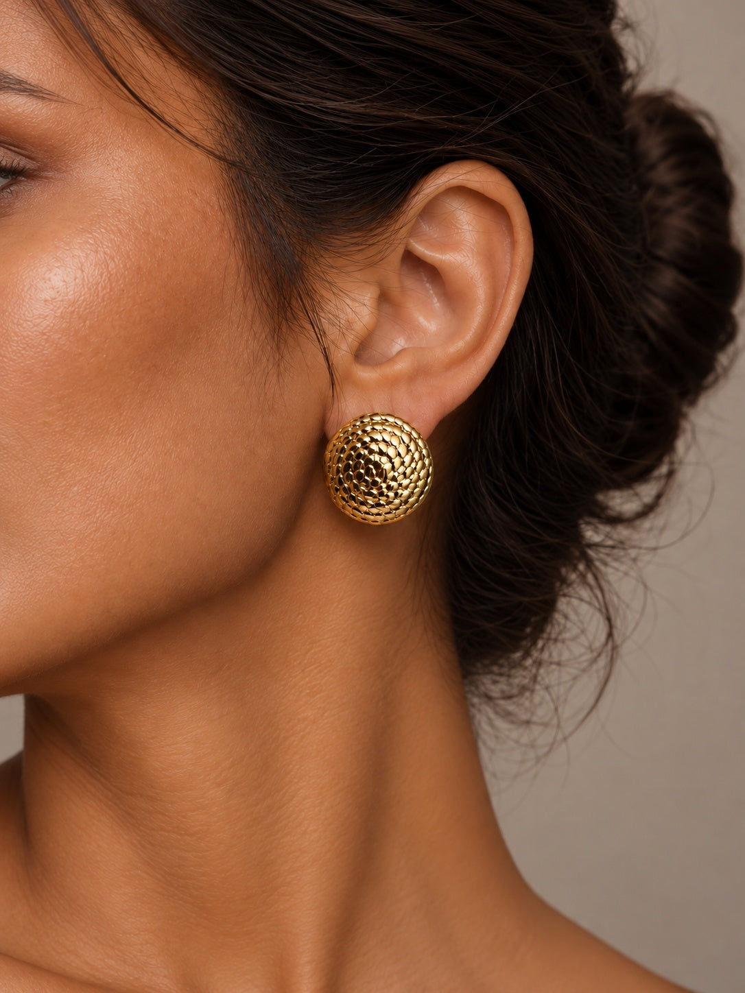 Niska gold-tone textured resin stud earrings worn by model