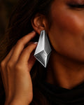 Model wearing Niska silver geometric statement earrings
