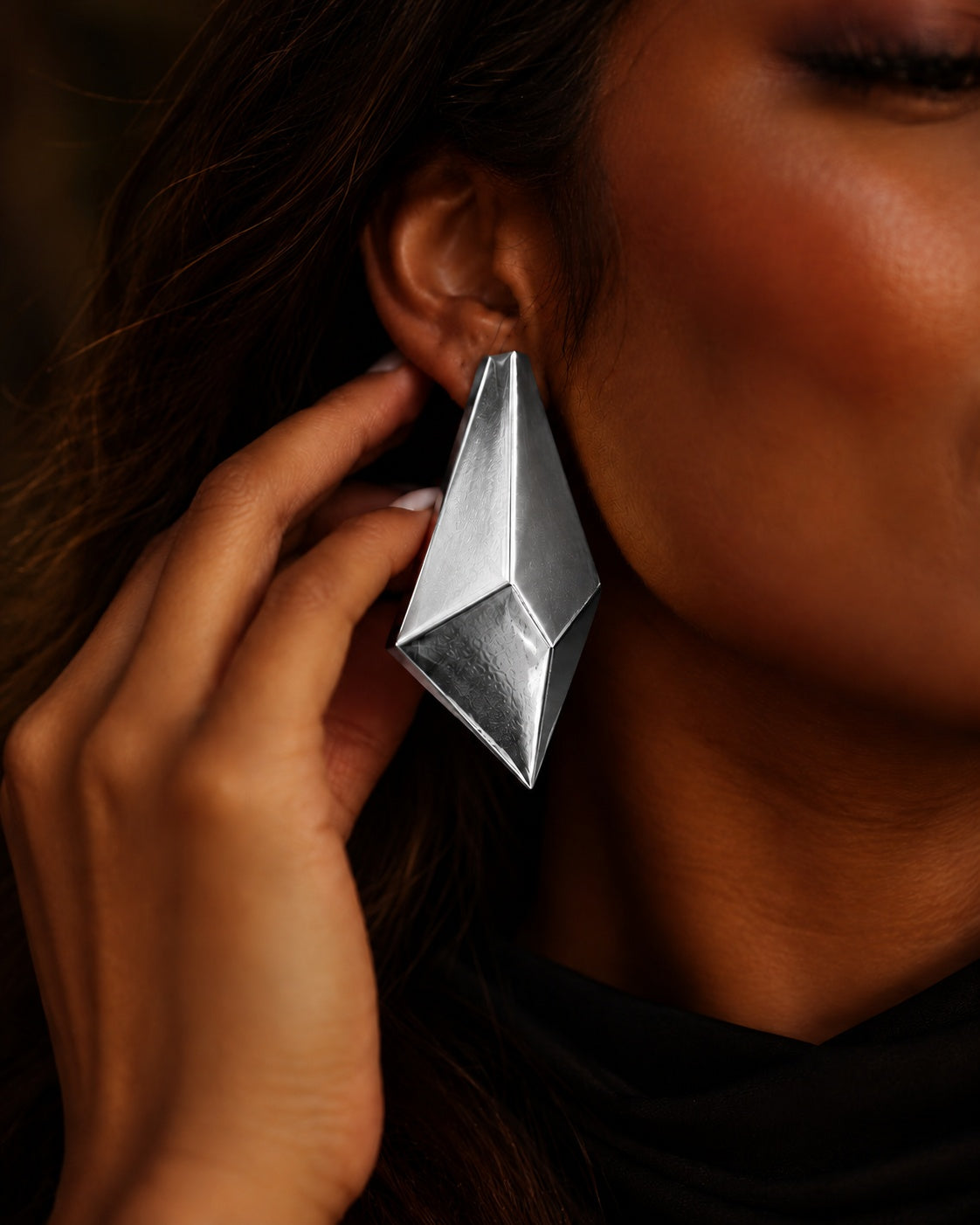 Model wearing Niska silver geometric statement earrings