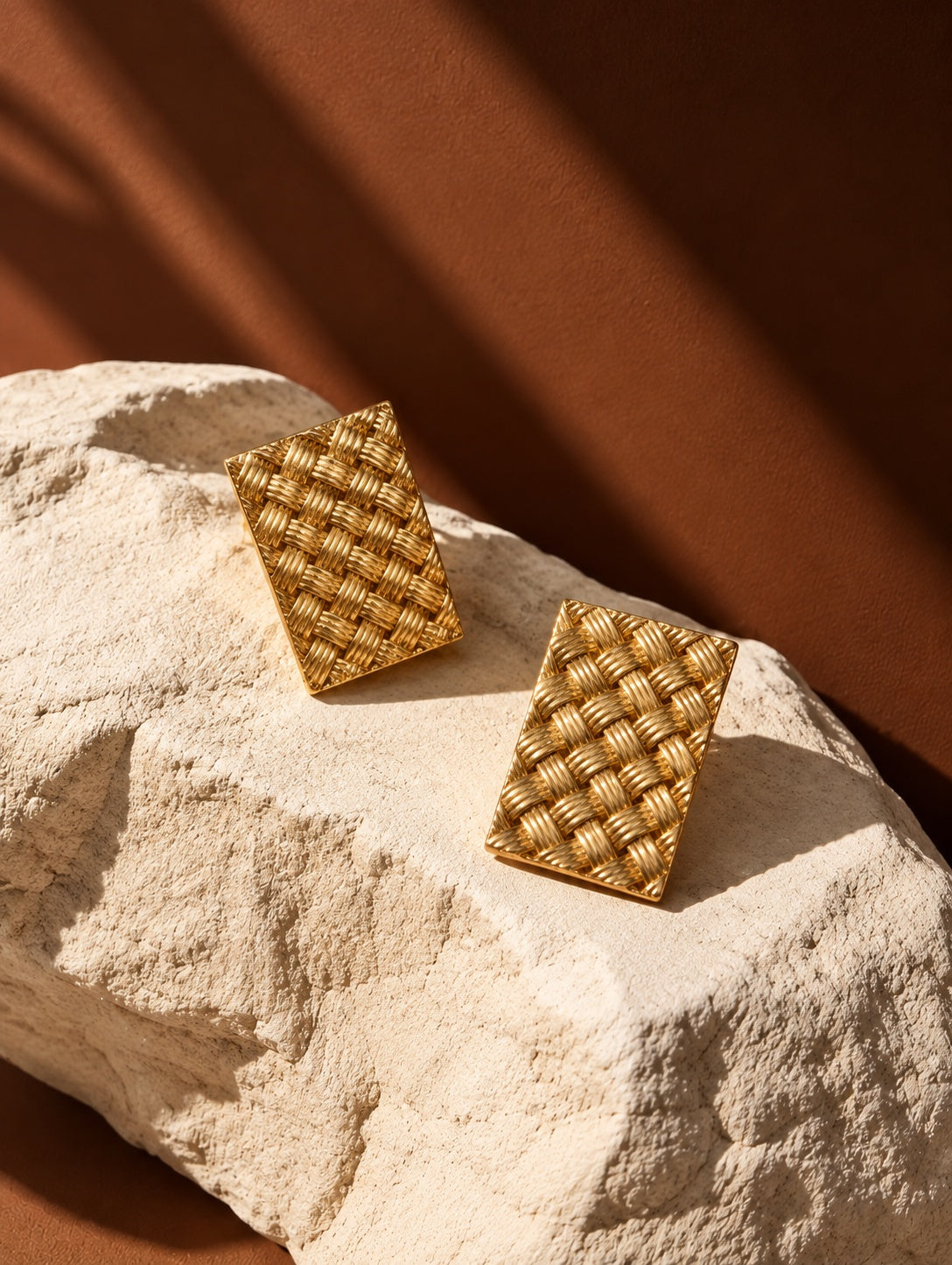 Gold woven rectangular earrings, close-up angle