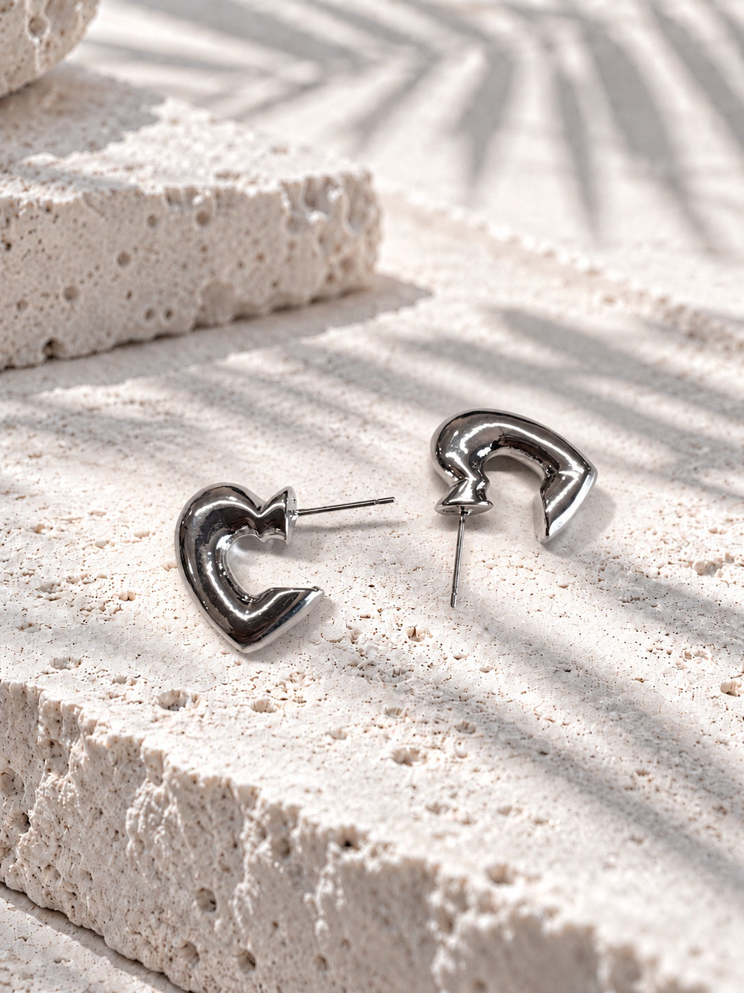 Model wearing Niska silver-tone open heart earrings