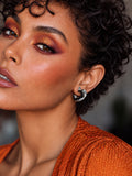 Model wearing Niska silver-tone open heart earrings