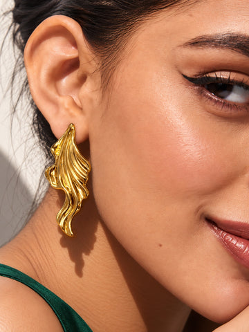 Niska gold-tone sculpted leaf Resin earring worn by model