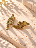 Niska gold-tone sculpted leaf Resin earrings on white travertine – view 1