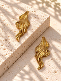 Niska gold-tone sculpted leaf Resin earrings on white travertine – view 5