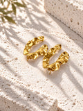 Niska gold-tone sculpted resin statement earrings on white travertine – view 4