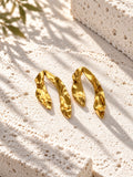 Niska gold-tone sculpted resin statement earrings on white travertine – view 5