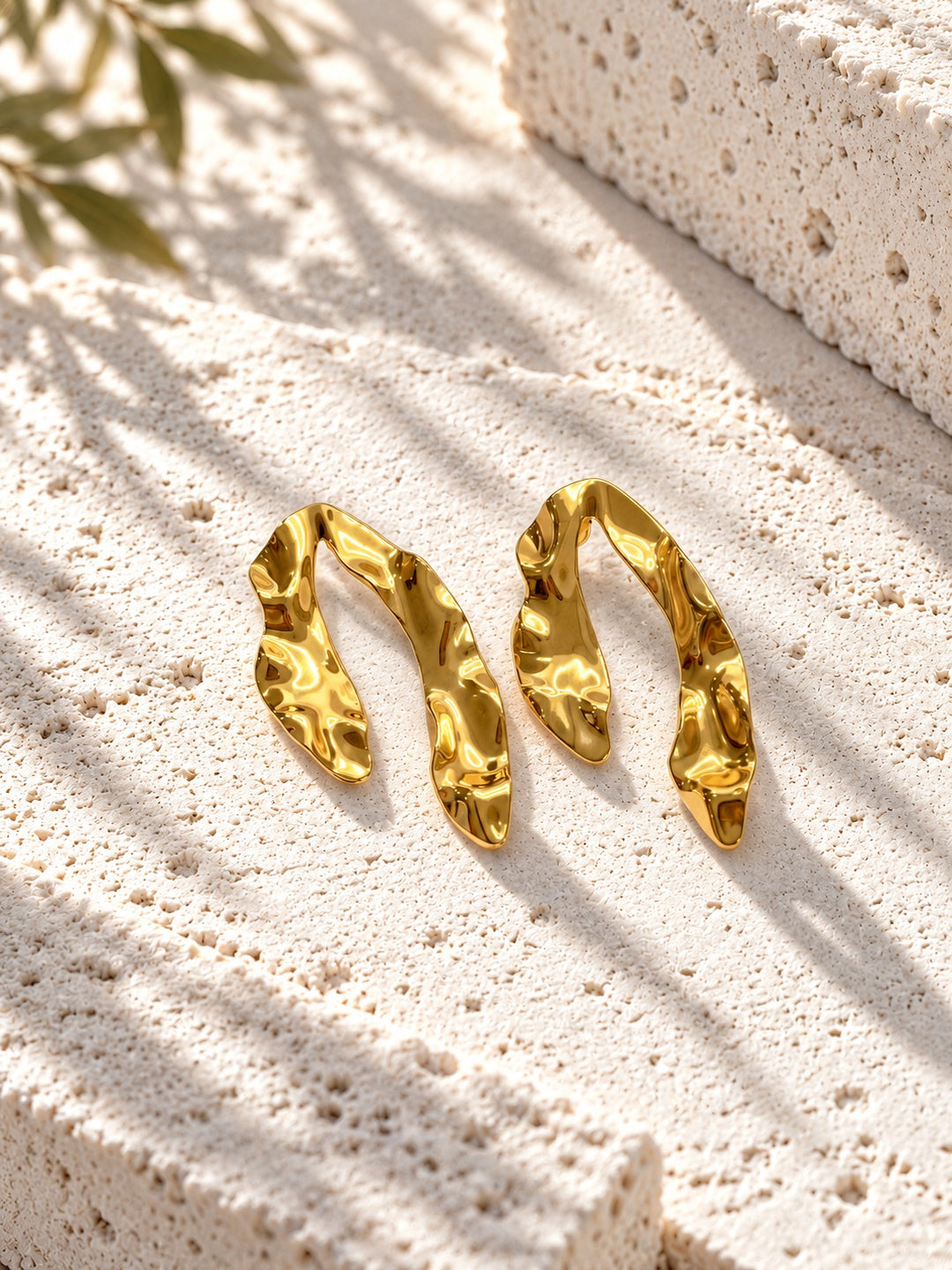 Niska gold-tone sculpted resin statement earrings on white travertine – view 5