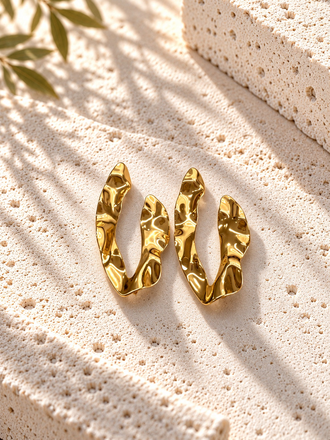 Niska gold-tone sculpted resin statement earrings on white travertine – view 7
