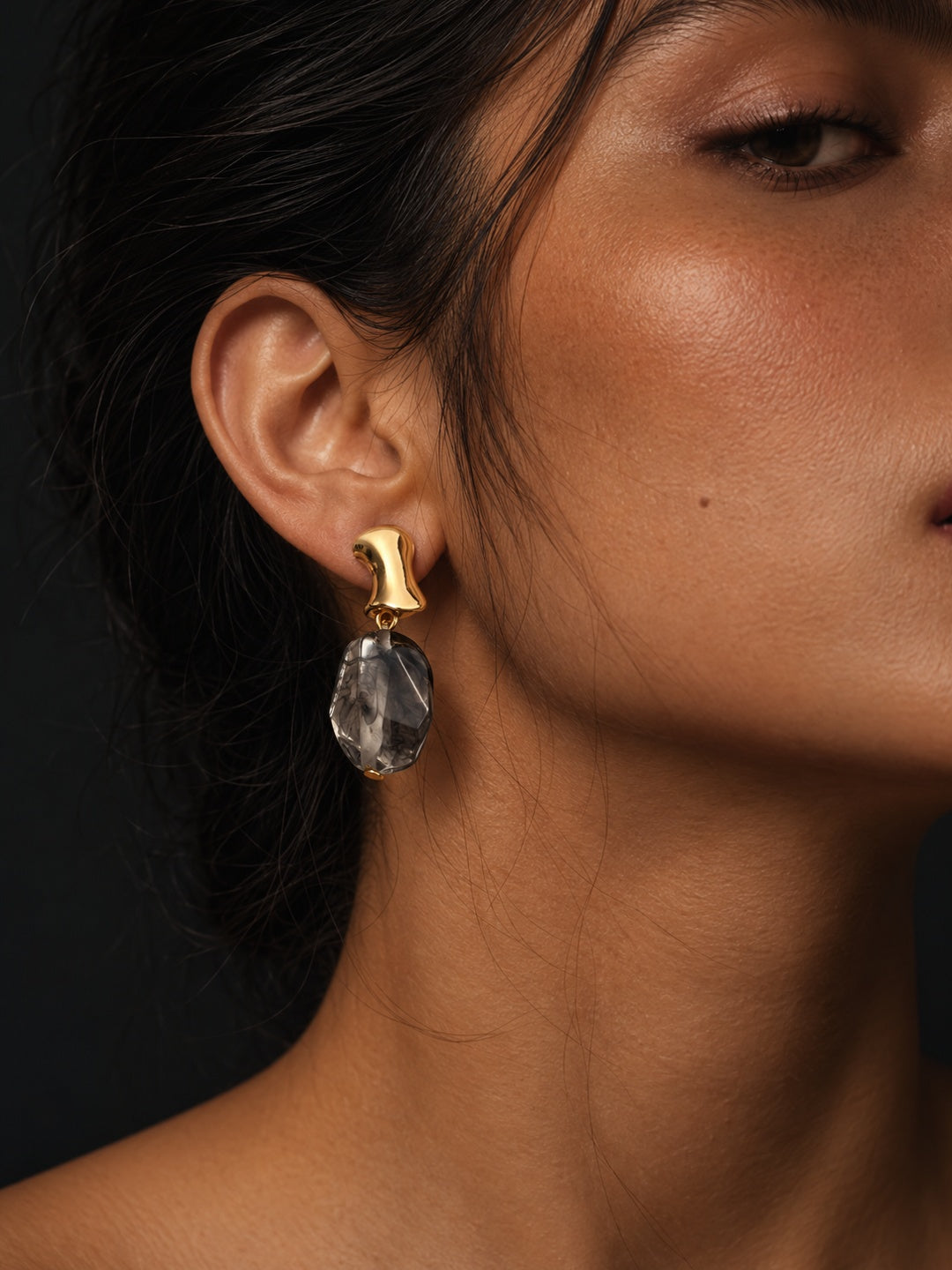 Niska smoky grey resin drop earring worn by model