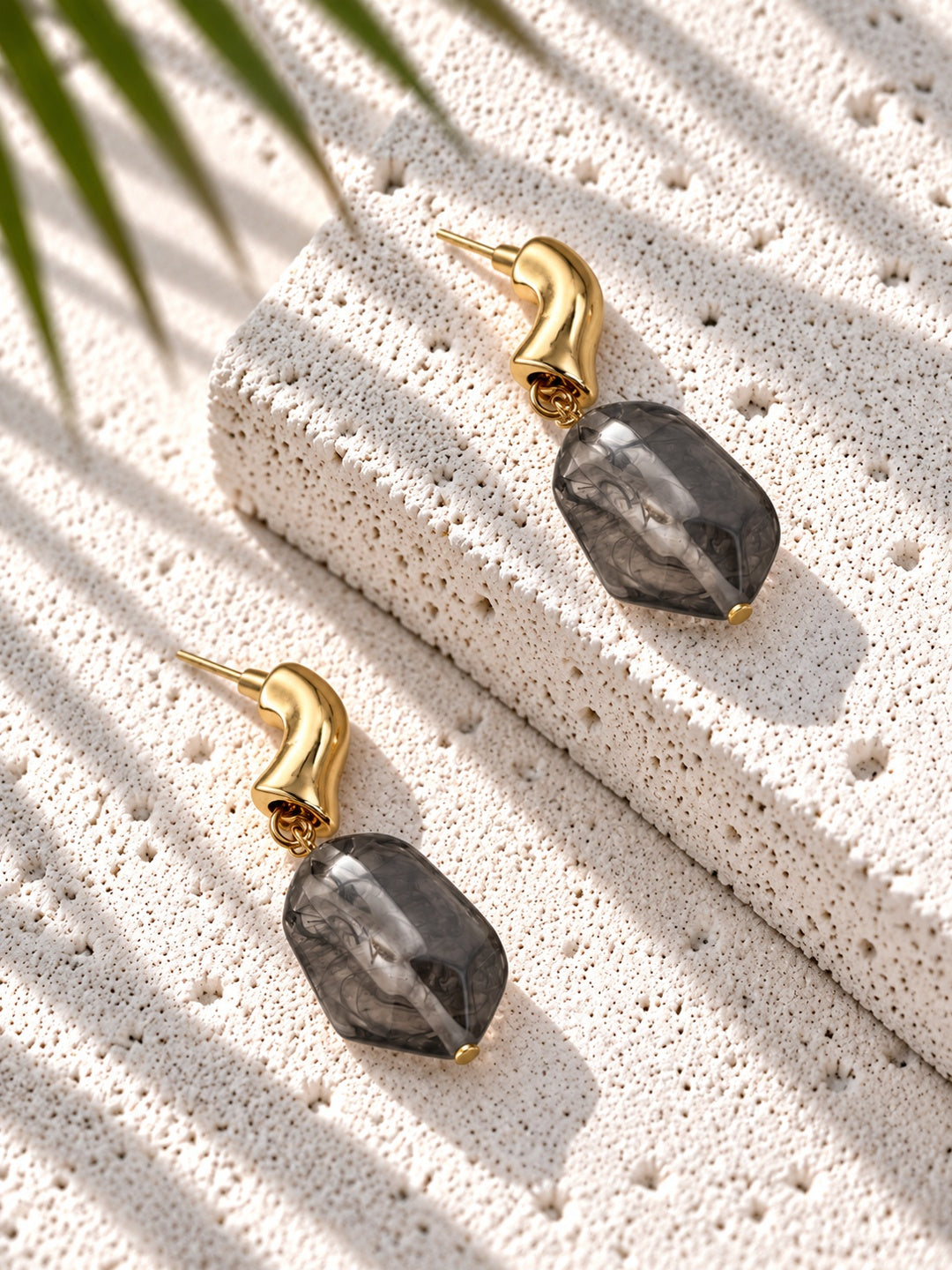 Niska smoky grey resin drop earring worn by model