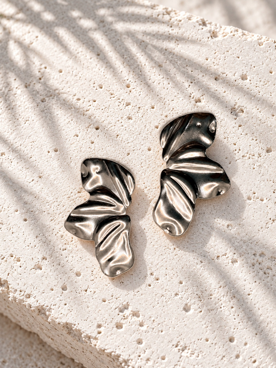 Sculptural folded silver-tone earrings staggered view
