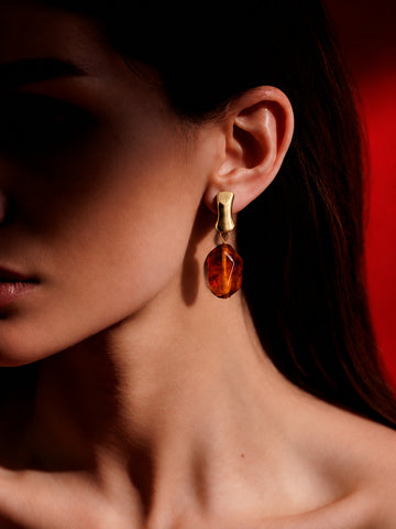 Model wearing Niska cognac amber colour drop earring