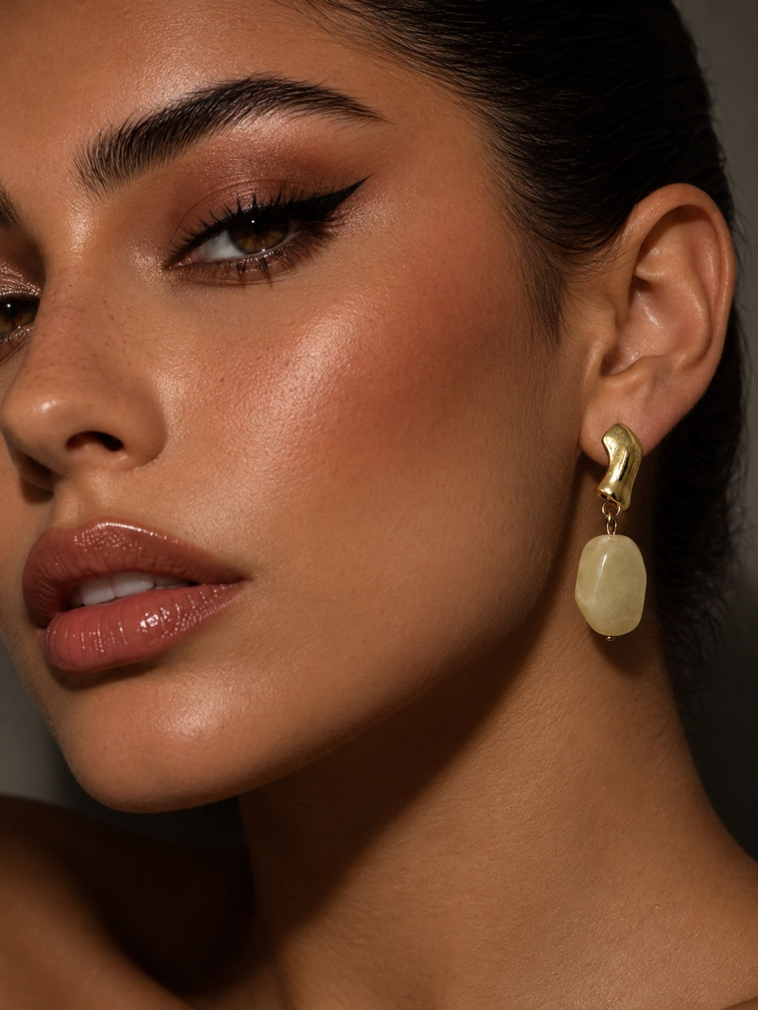 Model wearing pale yellow drop earring