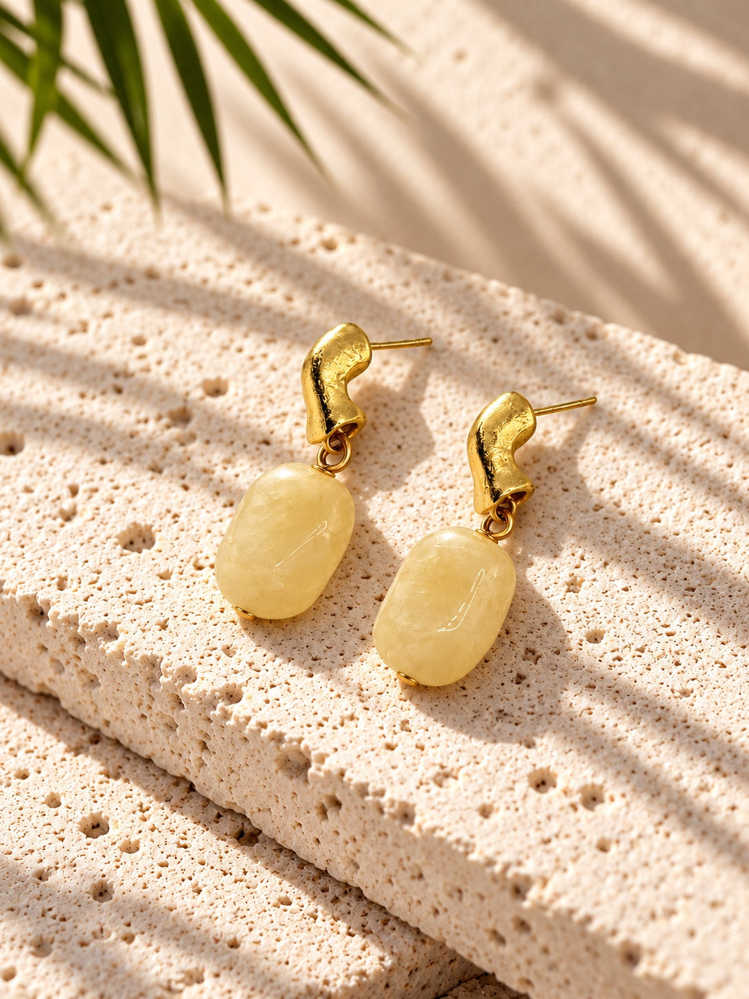Model wearing pale yellow drop earring