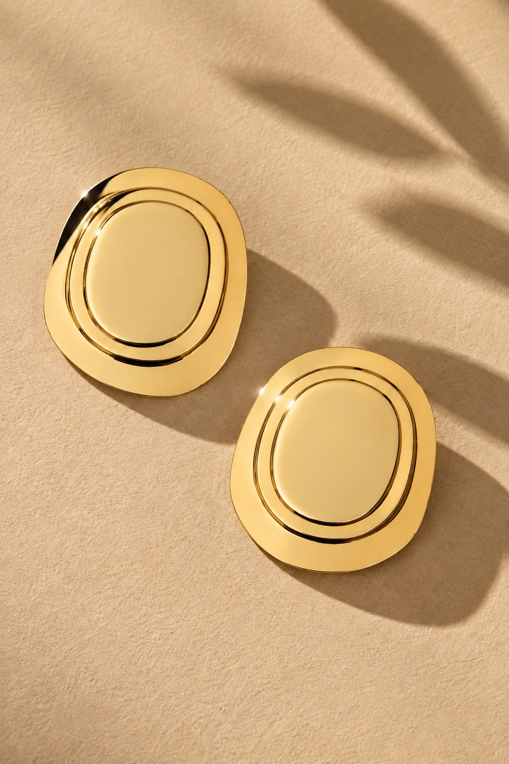 ER26N10277 gold concentric oval statement earrings – product angle 1