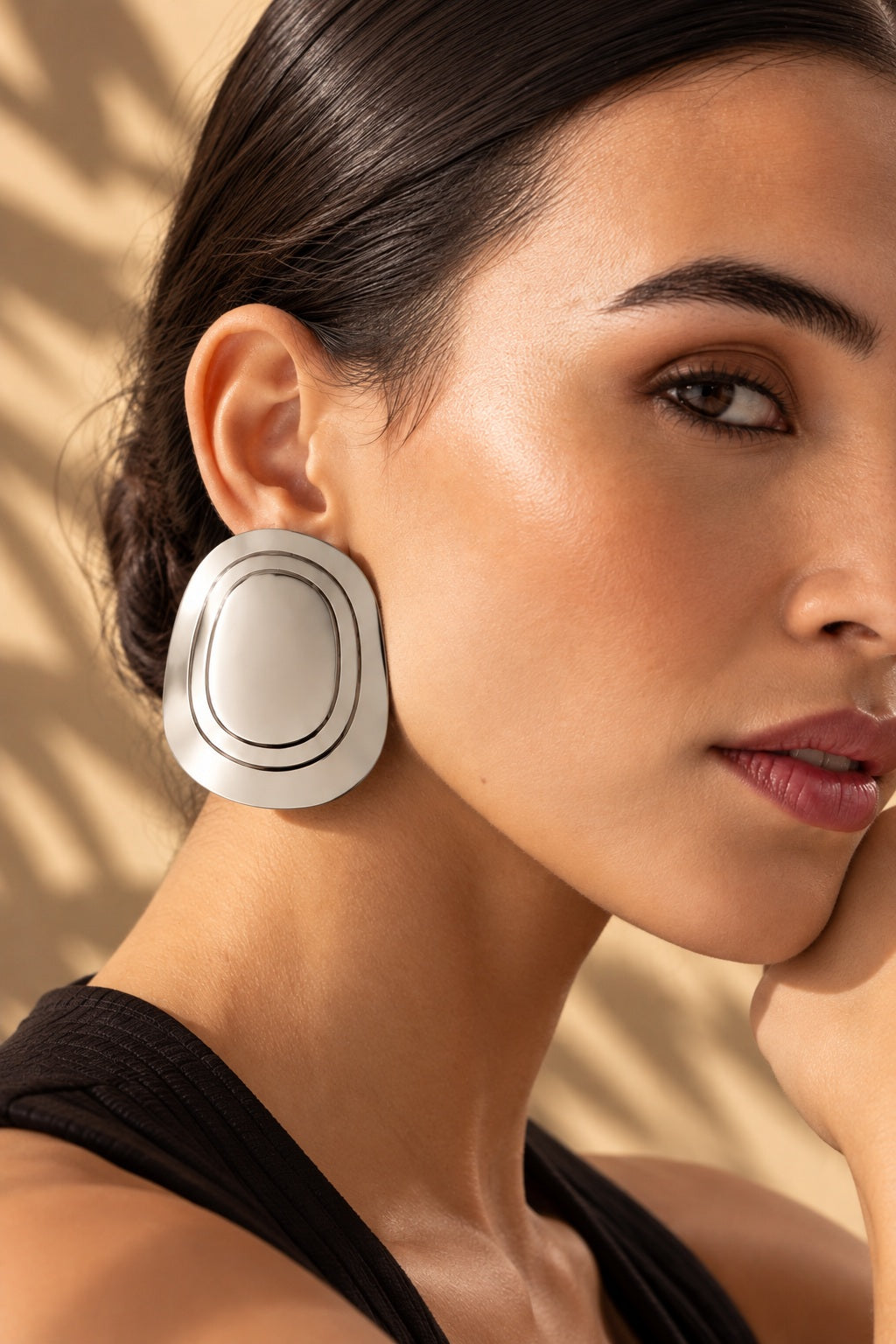 Close-up model image wearing silver concentric oval earring