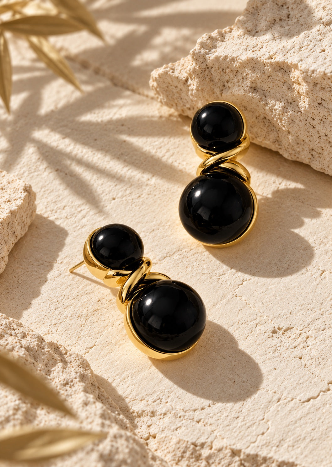 Alternate editorial angle of black and gold drop earrings
