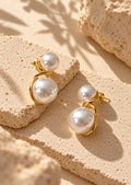 White pearl double-sphere earrings close-up product shot