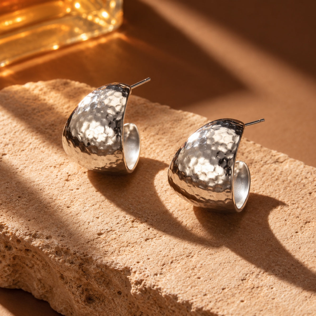 Silver hammered hoop earrings close-up still life