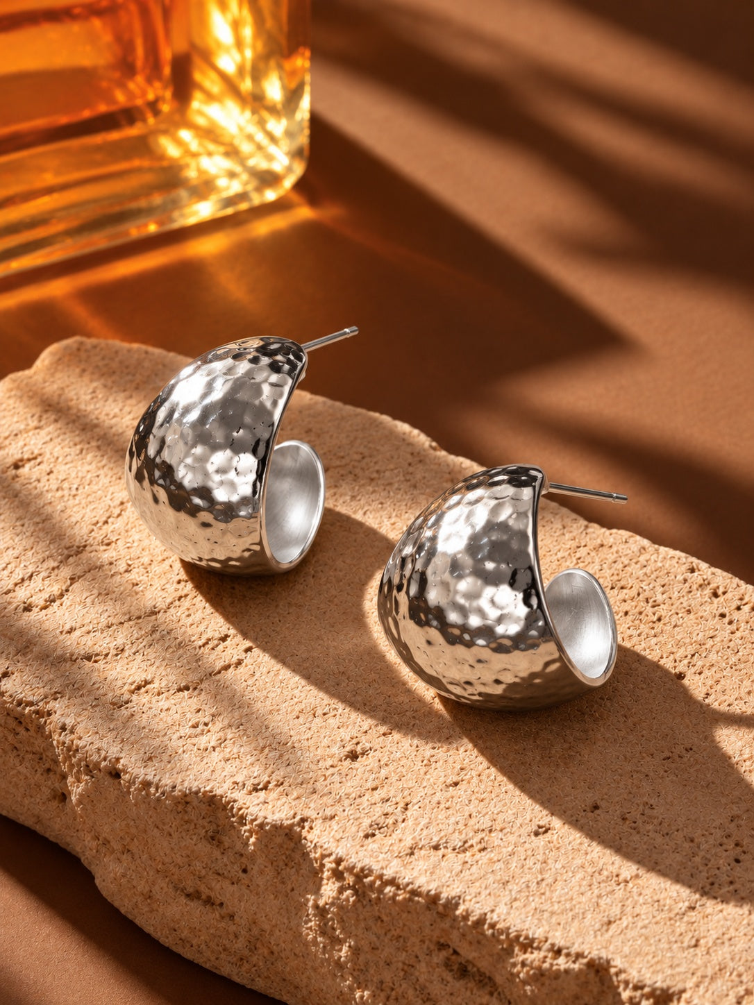 Silver hammered hoop earrings alternate still life angle