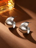 Silver hammered hoop earrings studio still life