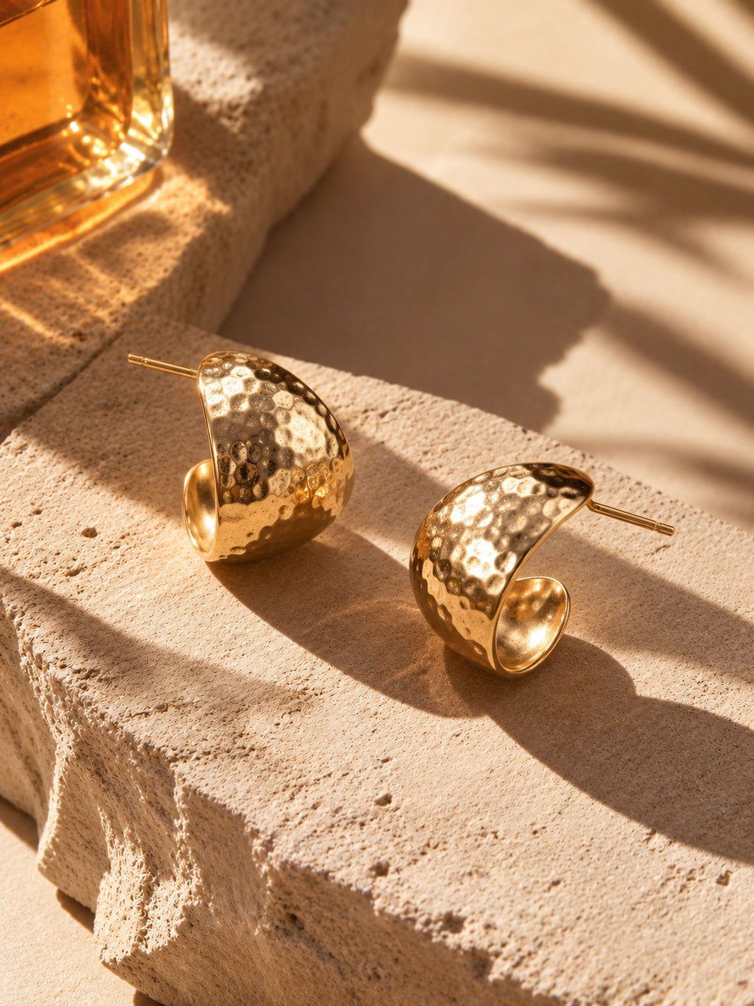 Hammered gold earrings alternate angle on stone