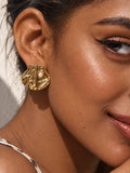 Niska gold-tone shell Resin pearl stud earring worn by model